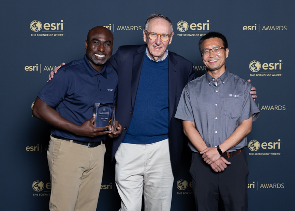 Halff's Sam Amoako-Atta and Zongpei Tang (right) pose with Jack Dangermond (middle) for the 2024 Esri Special Achievement in GIS Award